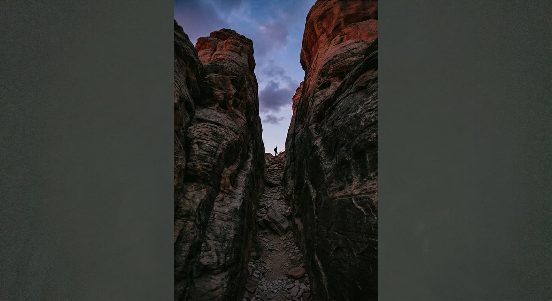 Sleek desktop AI workstation on a modern wooden office desk next to a widescreen monitor showing colorful AI agent dashboard visualizations