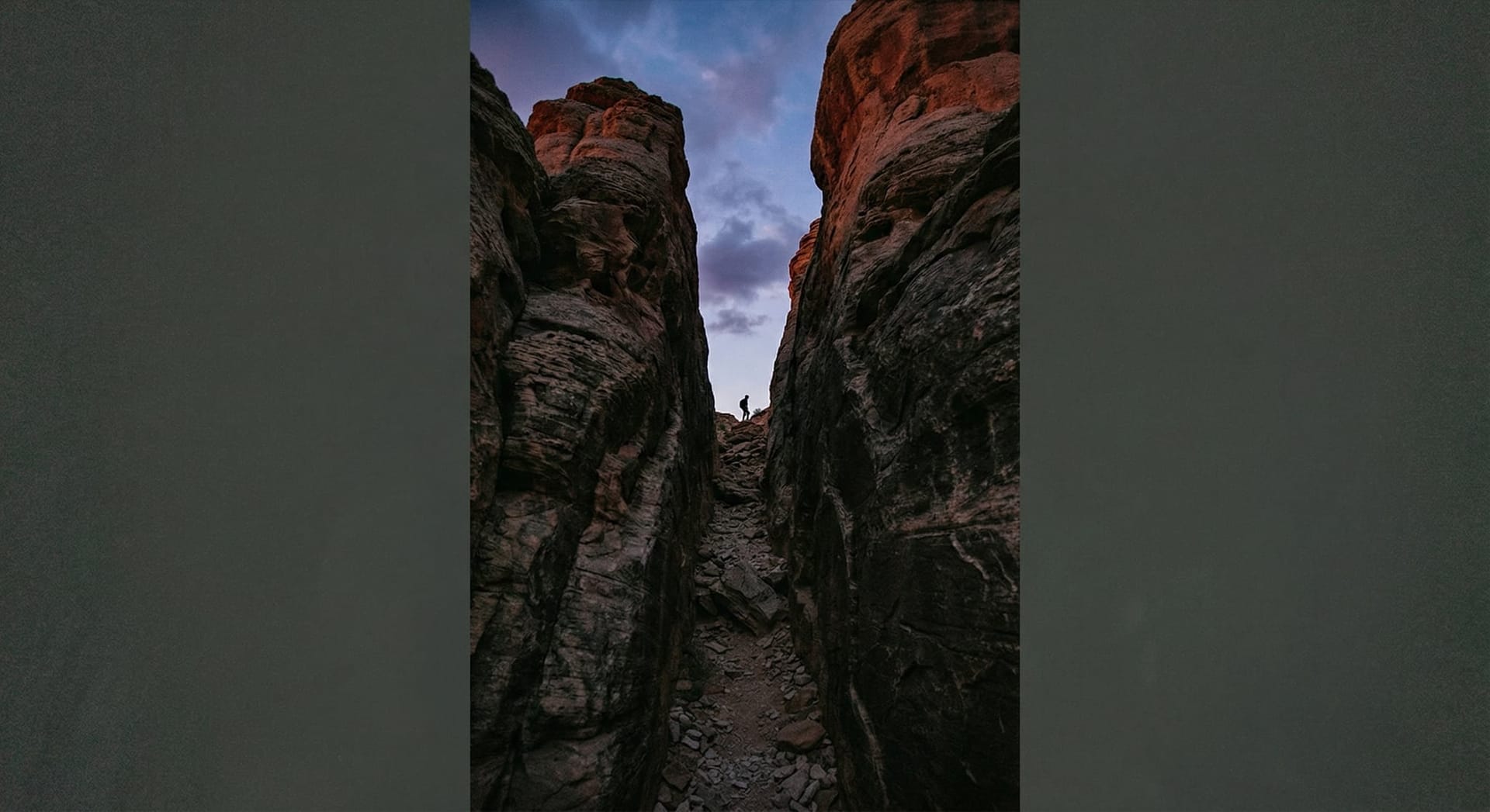Sleek desktop AI workstation on a modern wooden office desk next to a widescreen monitor showing colorful AI agent dashboard visualizations